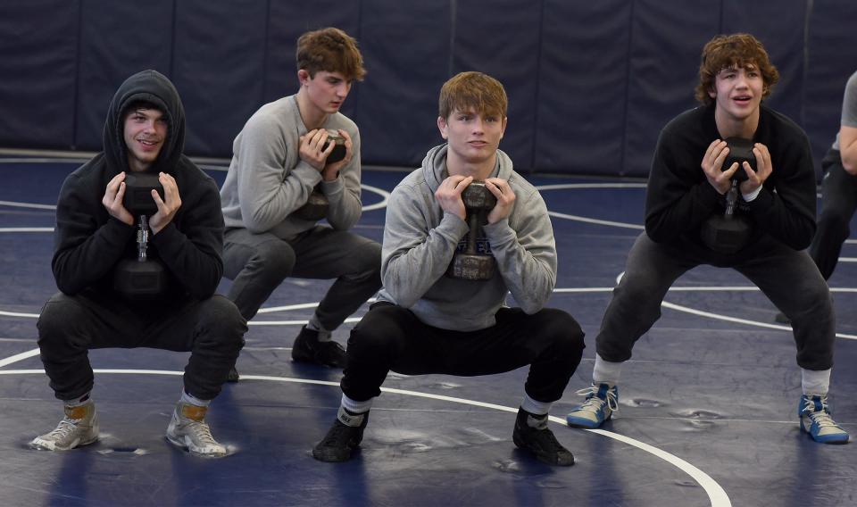 Cameron Chinavarre (132), Donny Beaufait (150), Kole Katschor (157) and Blake Cosby (144) run through strength and conditioning drills above two rounds of 20 goblet squats with weights this past Tuesday at practice at Dundee High School. The Vikings are preparing for the Individual State Wrestling Finals at Ford Field in Detroit Friday and Saturday.