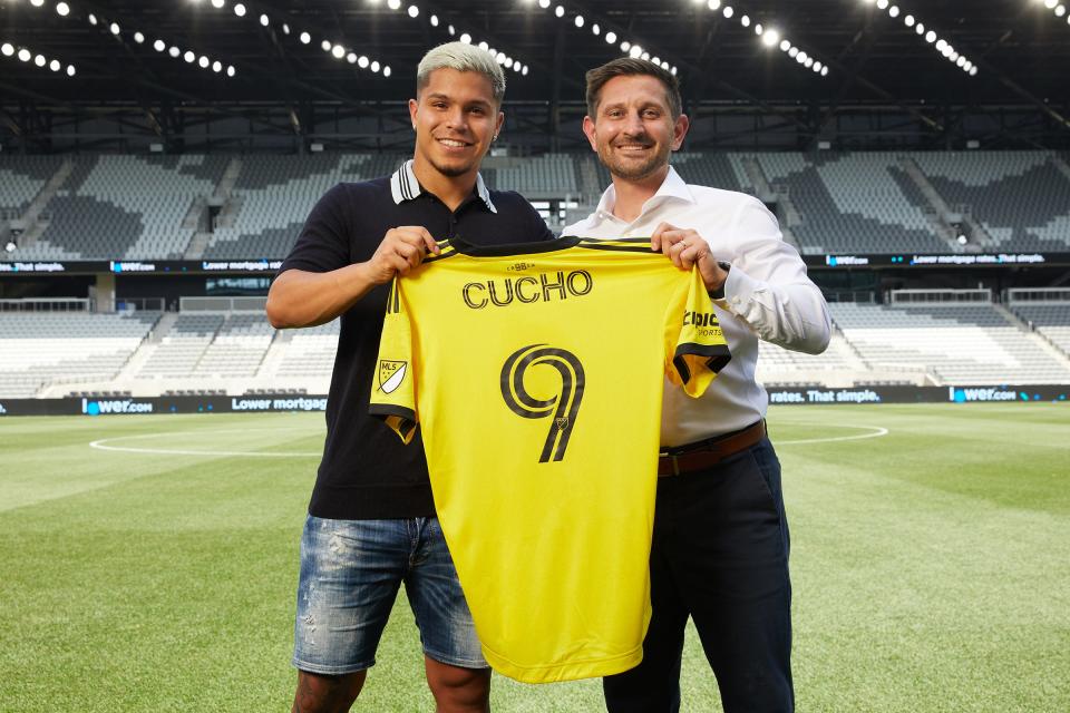 Crew general manager Tim Bezbatchenko and Colombian international striker Cucho Hernandez.