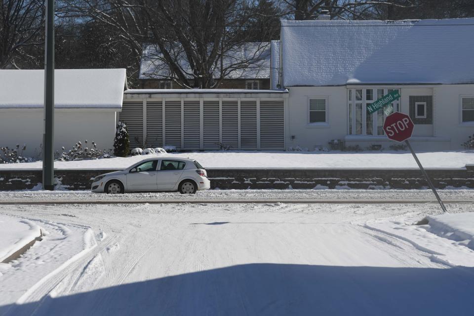 A car drives on North Highland Ave. as Jackson, Tenn., is blanketed by snow on Tuesday, Jan. 16, 2024.