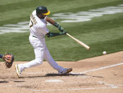Oakland Athletics' Elvis Andrus (17) hits a single against the Detroit Tigers during the fourth inning of a baseball game on Saturday, April 17, 2021, in Oakland, Calif. (AP Photo/Tony Avelar)