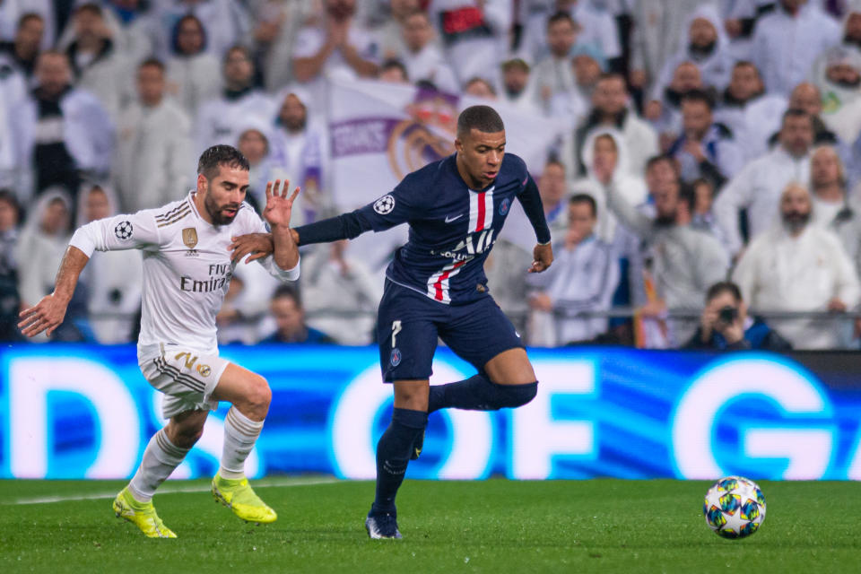 Kylian Mbappe (right) scored for PSG against Real Madrid on Tuesday, and is the apple of both clubs' eyes. (Photo by TF-Images/Getty Images)
