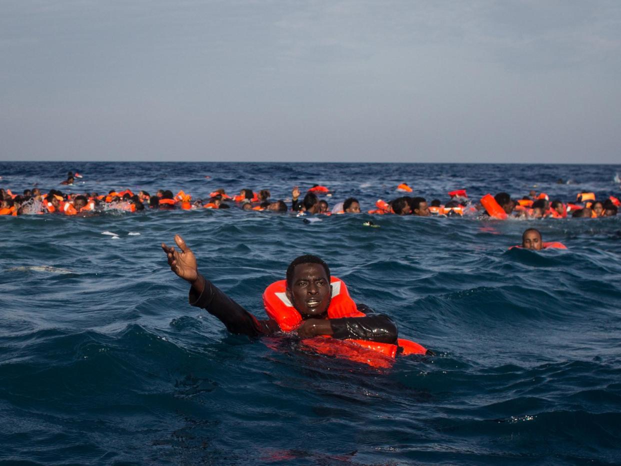 Refugees and migrants swimming and shouting for help from crew members from the Migrant Offshore Aid Station's Phoenix vessel off the coast of Italy, 24 May, 2017: Getty Images