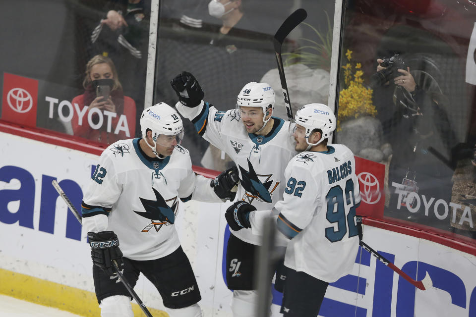 San Jose's Tomas Hertl, center, celebrates with teammates Patrick Marleau, left, and Rudolfs Blacers, right, after Hertl scored a goal during the first period of an NHL hockey game against the Minnesota Wild, Friday, April 16, 2021, in St. Paul, Minn. (AP Photo/Stacy Bengs)