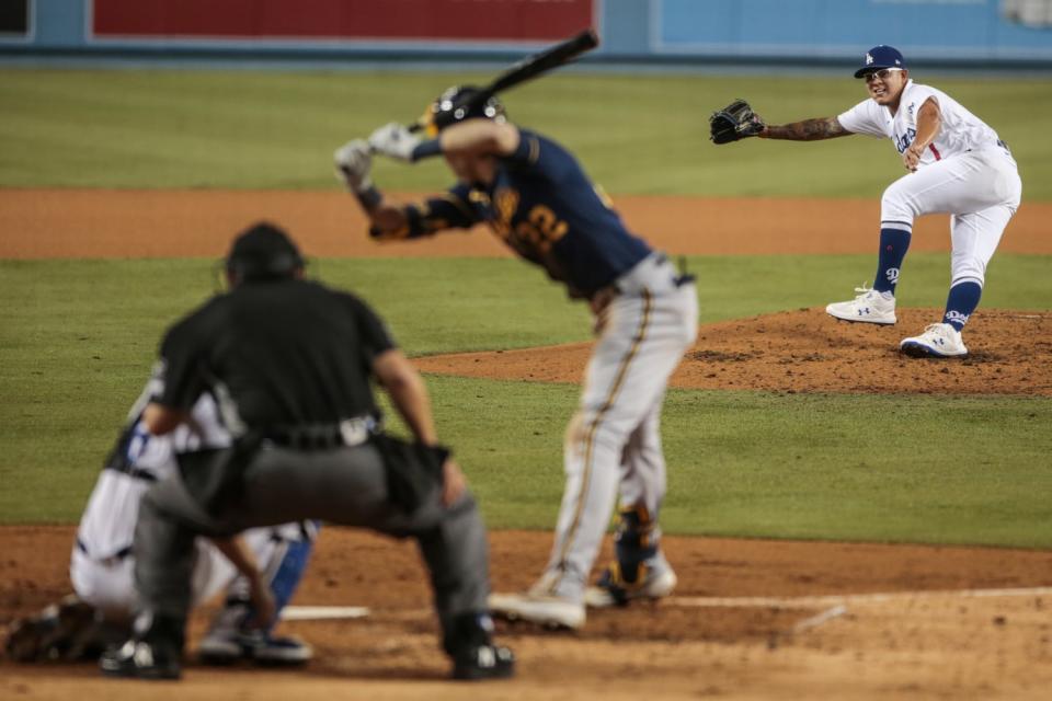 Dodgers reliever Julio Urias delivers to Milwaukee Brewers right fielder Christian Yelich in the fifth inning.