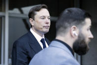 Elon Musk leave the Phillip Burton Federal Building and United States Court House in San Francisco, Tuesday, Jan. 24, 2023. Musk returned to federal court to defend himself against a class-action lawsuit that alleges he misled Tesla shareholders with a tweet about an aborted buyout that the billionaire defiantly insisted Tuesday he could have pulled off, had he wanted. (AP Photo/ Benjamin Fanjoy)