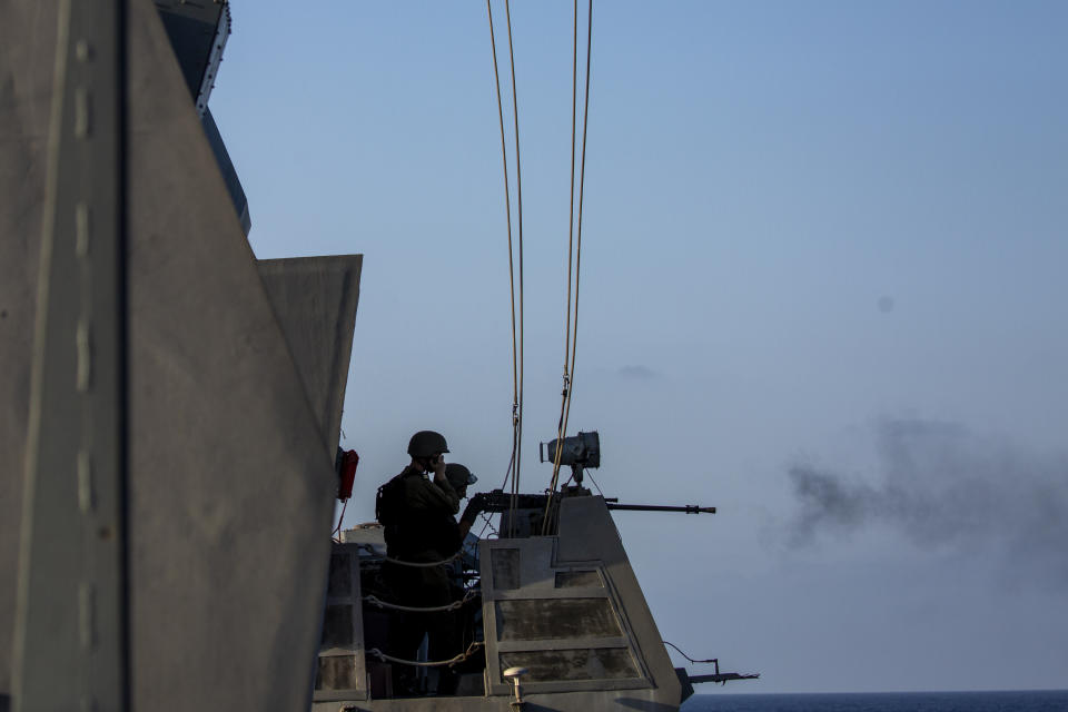 Israeli soldiers fire from their position on board the Israeli Navy Ship Lahav during a rare tour of Israel's offshore Leviathan gas field in the Mediterranean Sea, Tuesday, Sept. 29, 2020. After a coronavirus-related delay, Israel's navy is preparing for the long-awaited arrival of its next generation of missile boats - giving it a powerful new tool to defend its strategic natural gas industry from the threat of the Lebanese militant group Hezbollah. (AP Photo/Ariel Schalit)