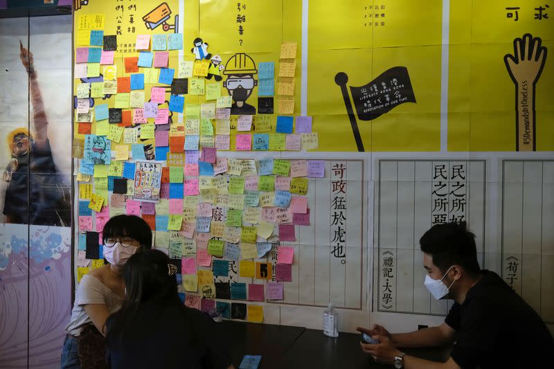 Customers sit inside a yellow restaurant called ''Mainichi'', during ''golden ween'' holiday by supporting local businesses with the pro-democracy views, in Hong Kong