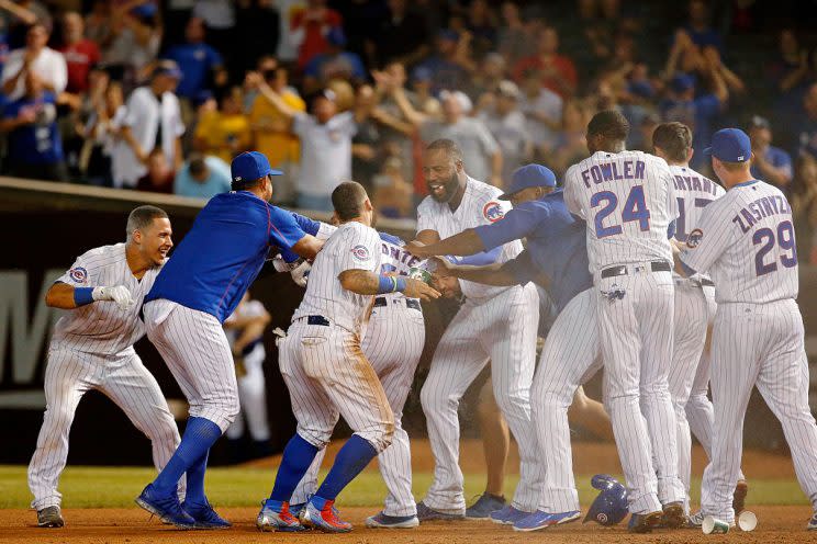 CHICAGO, IL - AUGUST 29: The Chicago Cubs try to rip off the jersey of Miguel Montero #47 after he hit a walkoff RBI single against the Pittsburgh Pirates during the thirteenth inning at Wrigley Field on August 29, 2016 in Chicago, Illinois. The Chicago Cubs won 8-7 in thirteen innings. (Photo by Jon Durr/Getty Images)