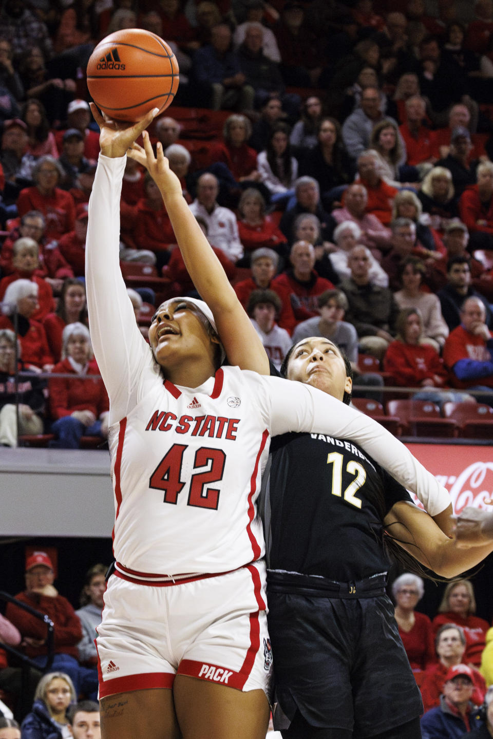 North Carolina State's Mallory Collier (42) attempts a shot as Vanderbilt's Khamil Pierre (12) defends during the first half of an NCAA college basketball game in Raleigh, N.C., Wednesday, Nov. 29, 2023. (AP Photo/Ben McKeown)