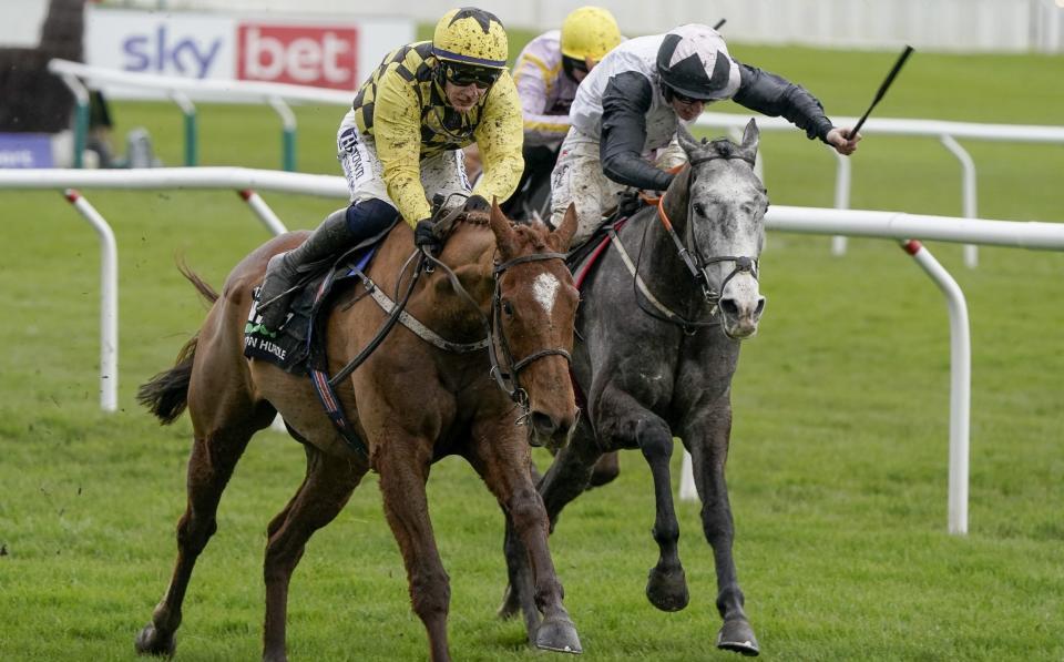 Paul Townend riding State Man (yellow/black) clear the last to win The Unibet Champion Hurdle Challenge Trophy