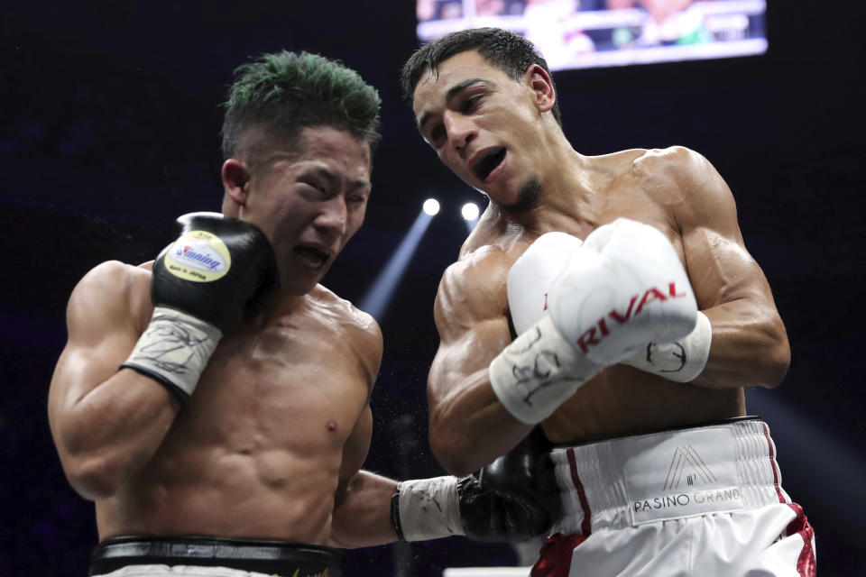 France's Nordine Oubaali, right, and Japan's Takuma Inoue exchange their punches in the ninth round of their WBC world bantamweight title match in Saitama, Japan, Thursday, Nov. 7, 2019. Oubaali defeated Inoue by a unanimous decision. (AP Photo/Toru Takahashi)