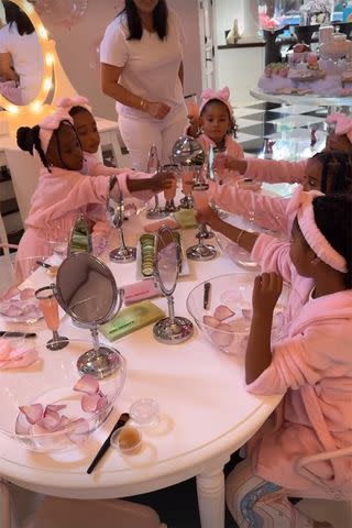 <p>Khloe Kardashian/Instagram</p> Dream and guests sipped on pink lemonade and wore pink robes at the bash