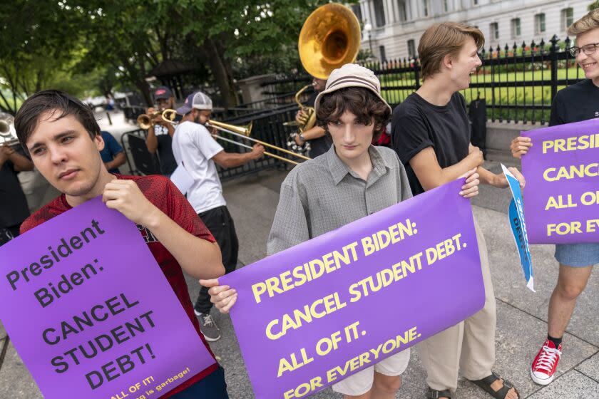 Too Much Talent Band performs during a rally to urge President Joe Biden to cancel student debt near the White House in Washington, Wednesday, July 27, 2022. (AP Photo/Andrew Harnik)