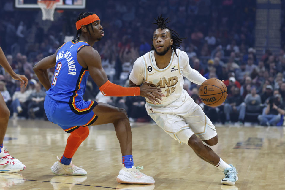 Cleveland Cavaliers guard Darius Garland (10) drives against Oklahoma City Thunder guard Shai Gilgeous-Alexander (2) during the first half of an NBA basketball game, Saturday, Dec. 10, 2022, in Cleveland. (AP Photo/Ron Schwane)