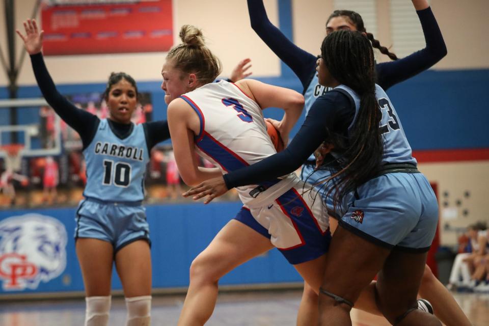Gregory-Portland’s Bella Davis is heavily guarded by Carroll defense during the District 29-5A crossover playoff game on Tuesday, Feb. 6, 2024, in Portland, Texas.