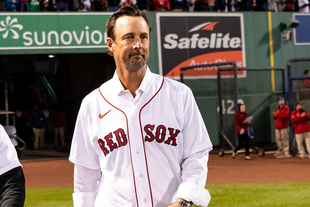 <p>Billie Weiss/Boston Red Sox/Getty</p> Tim Wakefield throwing a ceremonial first pitch in 2021.