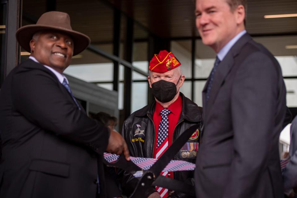 Developer Theo Bell, left, guest of honor World War II veteran Jack Thurman of Loveland and U.S. Sen. Michael Bennet participate in a ribbon cutting ceremony for the new Northern Colorado Veterans Affairs Outpatient Clinic in Loveland on Friday.