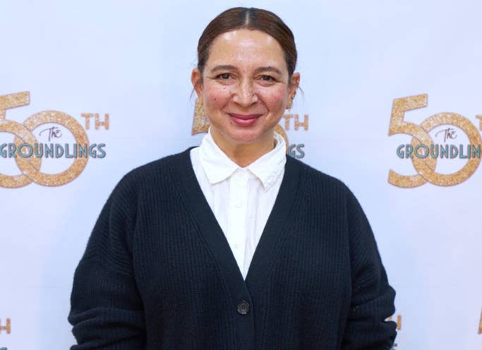 Maya Rudolph poses in a white shirt and black cardigan at The Groundlings event