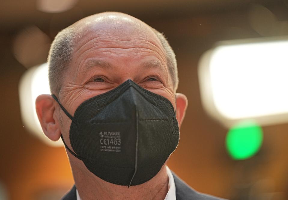 Olaf Scholz, SPD candidate for Chancellor and acting Federal Minister of Finance, arrives at the SPD party conference at Willy Brandt House in Berlin, Saturday, Dec. 4, 2021. Delegates vote on a coalition agreement with the FDP and Bündnis90/Die Grünen to form a new federal government. (Michael Kappeler/dpa via AP)