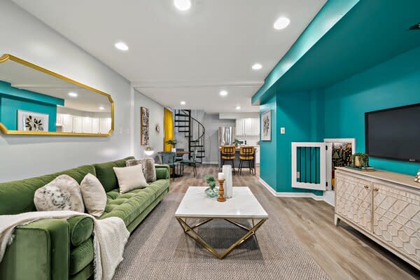 Vibrant splashes of color continue in the main living room, located on the second level just steps from the kitchen.