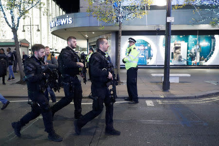 Armed police officers walk along Oxford Street, London, Britain November 24, 2017. REUTERS/Peter Nicholls