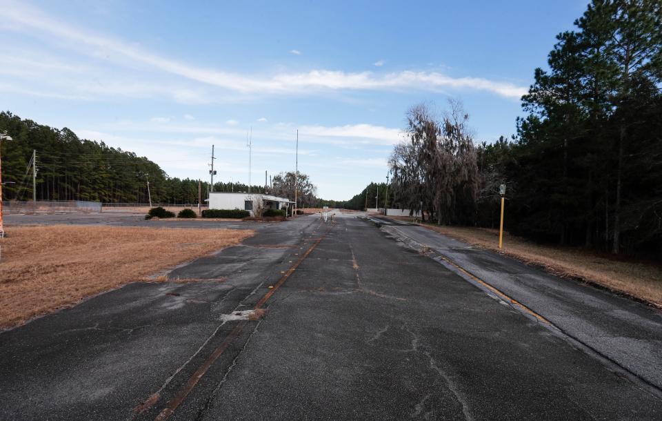 An aging road and a lone building are al that is visible from the gate at the former Thiokol facility in Woodbine, Georgia.