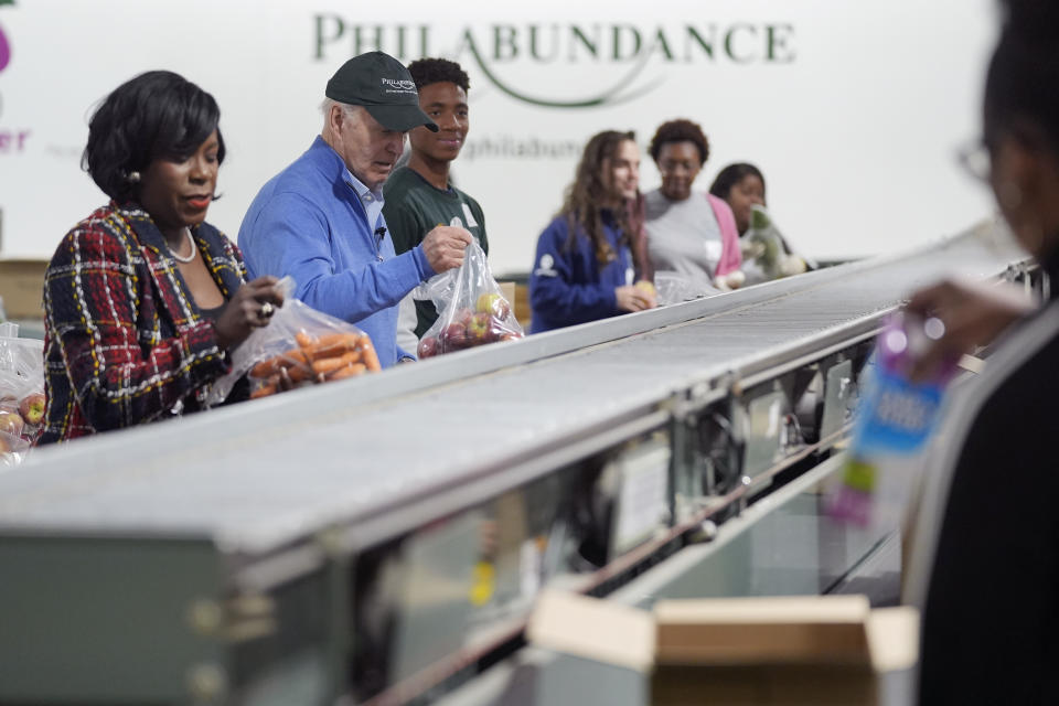 President Joe Biden volunteers at Philabundance, a hunger relief organization, to mark Martin Luther King, Jr., day, Monday, Jan. 15, 2024, in Philadelphia, with Philadelphia Mayor Cherelle Parker, left. (AP Photo/Evan Vucci)