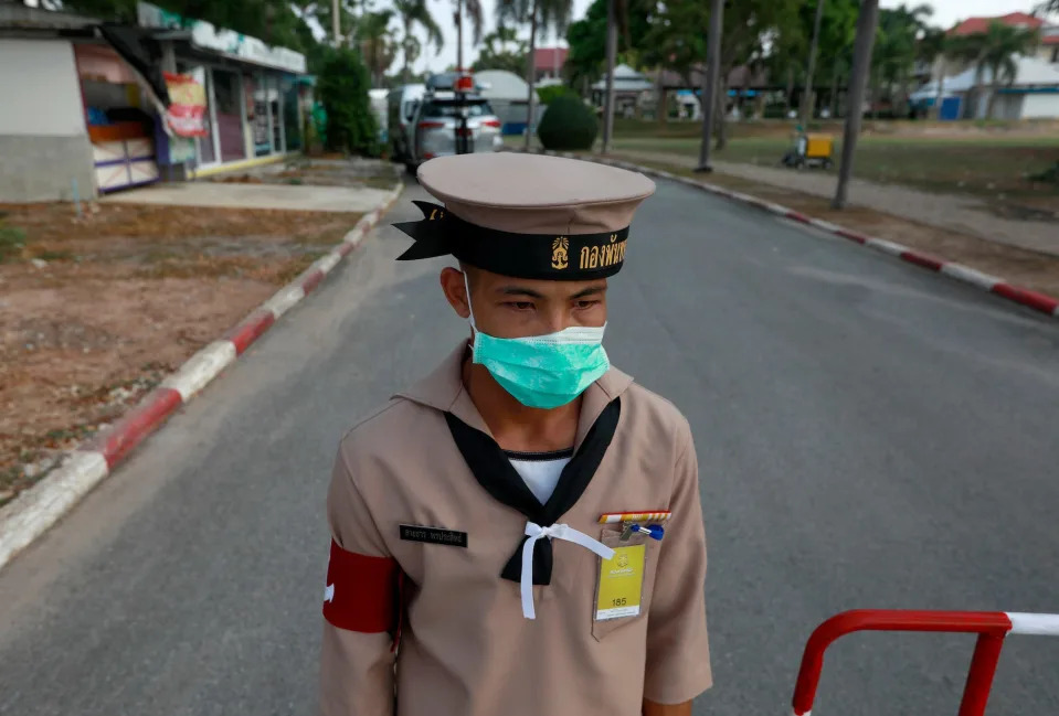 A Thai Navy sailor in a facemask