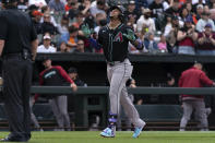 Arizona Diamondbacks' Ketel Marte, center, scores during a baseball game against the Baltimore Orioles, Saturday, May 11, 2024, in Baltimore. (AP Photo/Jose Luis Magana)