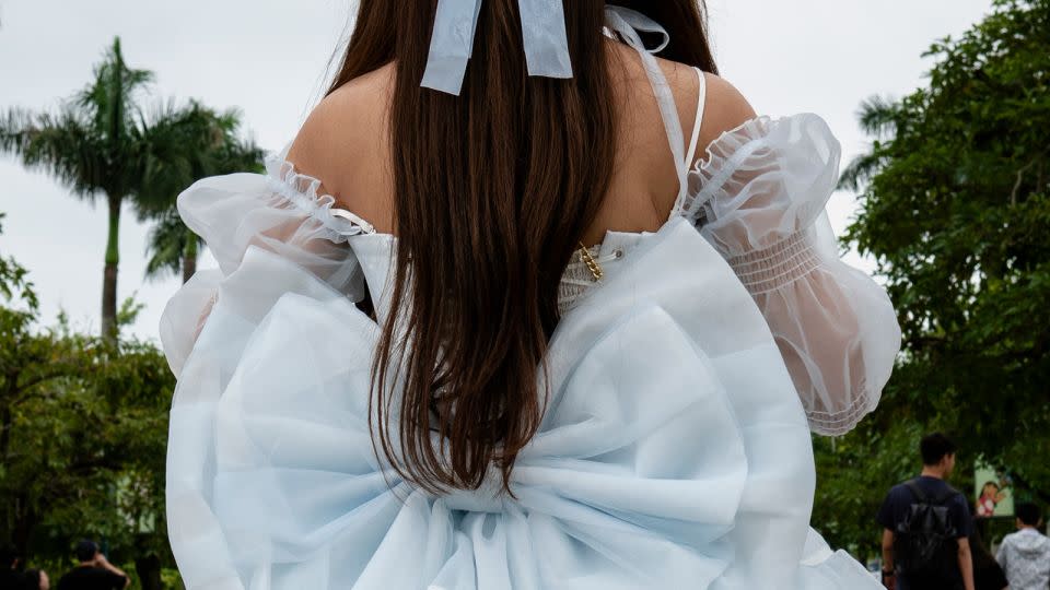 A giant bow adorns the back of her minidress. - Noemi Cassanelli/CNN