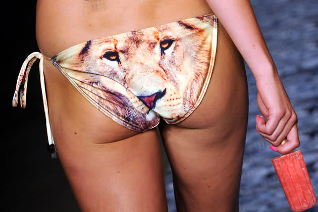 A model parades a lion print bikini during We Are Handsome's spring/summer show at Fashion Week Australia in Sydney on May 3, 2012. The annual event showcases over 75 collections by renowned Australian and Asian designers. AFP PHOTO / Torsten BLACKWOOD