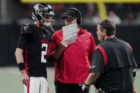 Atlanta Falcons head coach Arthur Smith speaks with Atlanta Falcons quarterback Matt Ryan (2) during the first half of an NFL football game against the Tampa Bay Buccaneers, Sunday, Dec. 5, 2021, in Atlanta. (AP Photo/John Bazemore)