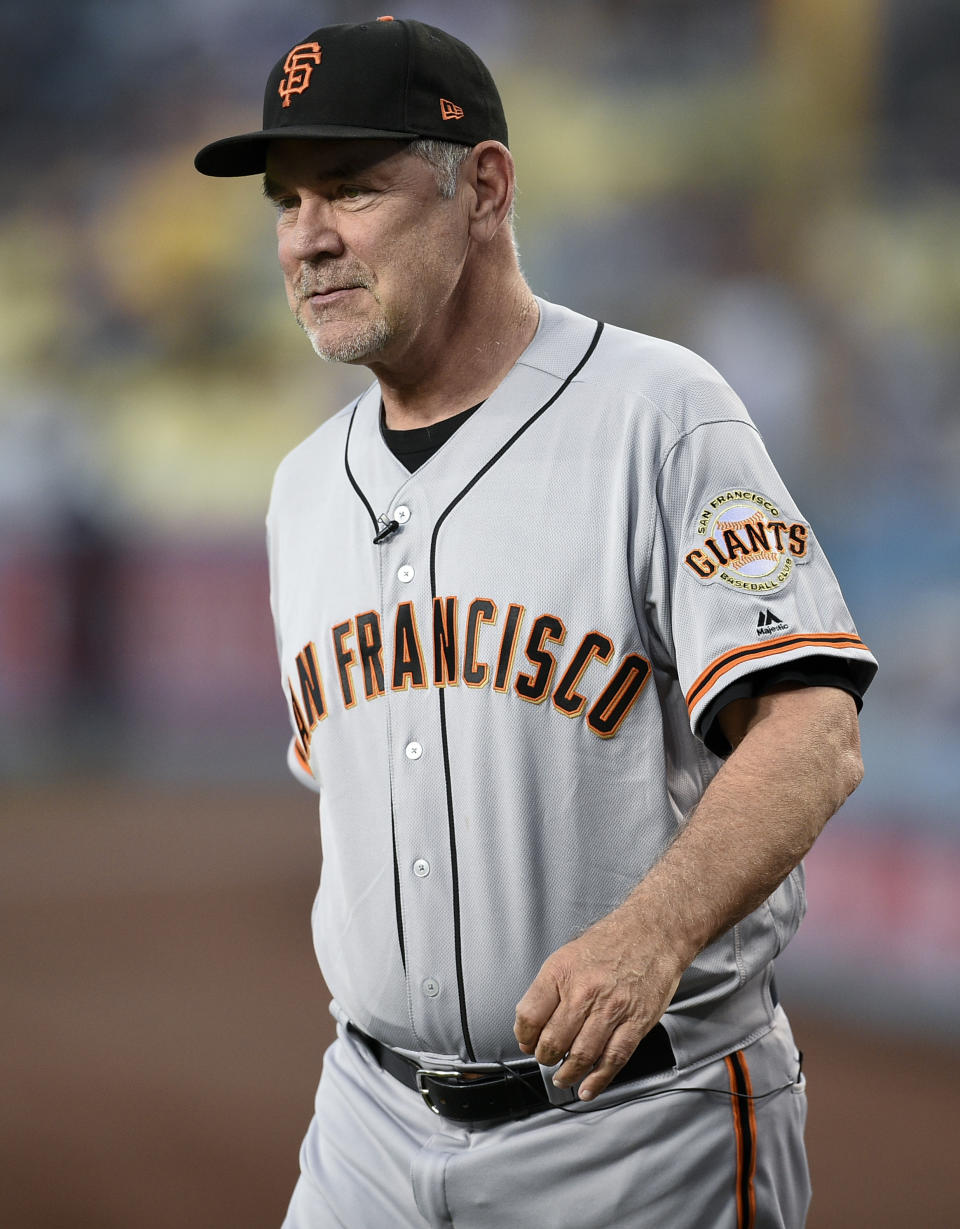 FILE - San Francisco Giants manager Bruce Bochy walks onto the field prior to a baseball game against the Los Angeles Dodgers in Los Angeles, Friday, Sept. 6, 2019. The Texas Rangers have hired Bruce Bochy as their new manager, bringing the three-time World Series champion out of retirement to take over a team that has had six consecutive losing seasons. Texas made the surprise announcement Friday, Oct. 21, 2022, just more than two weeks after its season ended. (AP Photo/Kelvin Kuo, File)