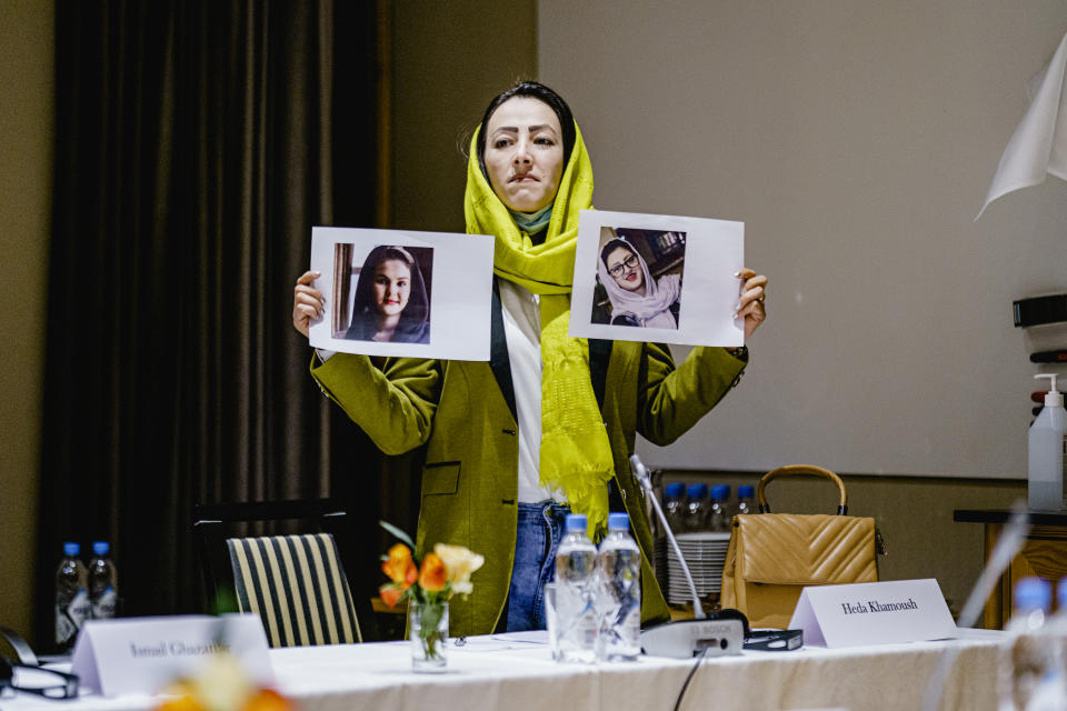 Delegate from the Afghan civil society Heda Khamoush holds up photos of two women who have vanished, ahead of a meeting, in Oslo, Norway, Monday, Jan. 24, 2022. Western diplomats are meeting with Afghan women’s rights activists and human rights defenders in Oslo ahead of the first official talks with the Taliban in Europe since the Taliban took over in August. The closed-door meeting was a chance to hear from civil society in Afghanistan and the Afghan diaspora their demands and assessment of the current situation on the ground. The meeting was taking place at a hotel in the snow-capped mountains above the Norwegian capital and was attended by representatives of the EU, the US, the United States, France, Italy and hosts Norway. (Stian Lysberg Solum / NTB via AP)