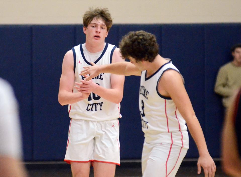 Jaden Alger (left), Ryan Spate and the Boyne City boys' basketball team celebrated a Lake Michigan win Tuesday on the road.