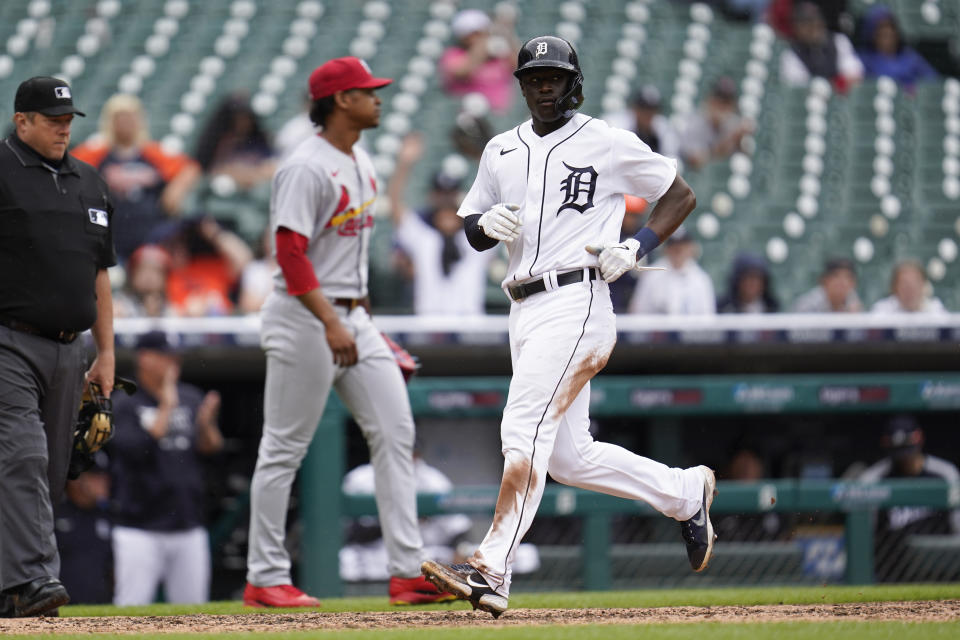 Detroit Tigers' Daz Cameron, right, scores in the eighth inning of a baseball game against the Detroit Tigers in Detroit, Wednesday, June 23, 2021. (AP Photo/Paul Sancya)