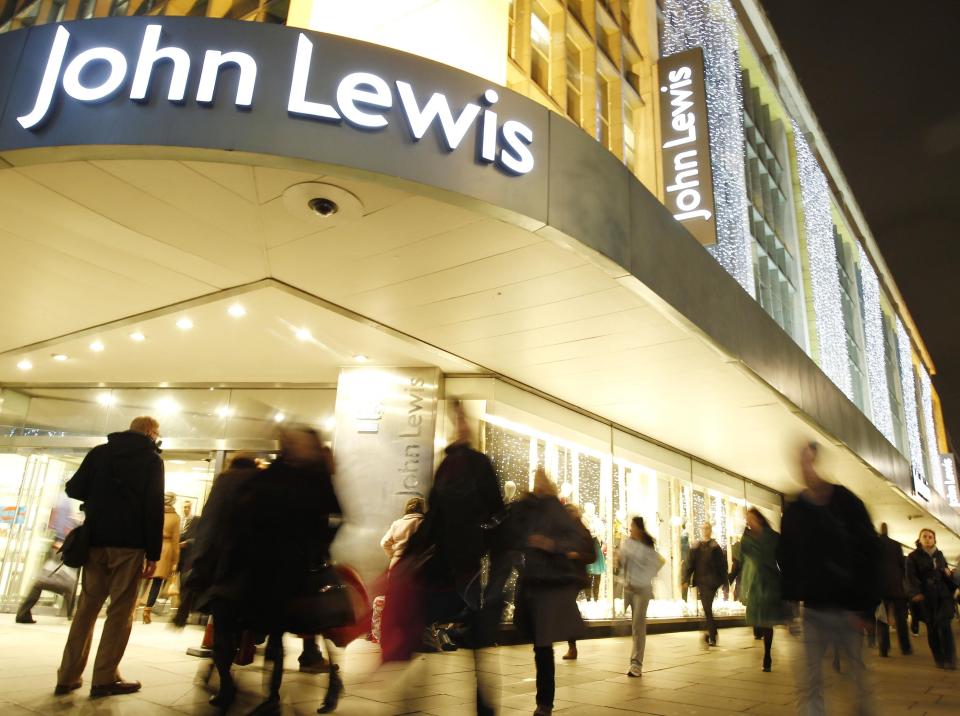 Shoppers pass John Lewis department store on Oxford Street in London December 8, 2011.    REUTERS/Luke MacGregor  (BRITAIN - Tags: BUSINESS)