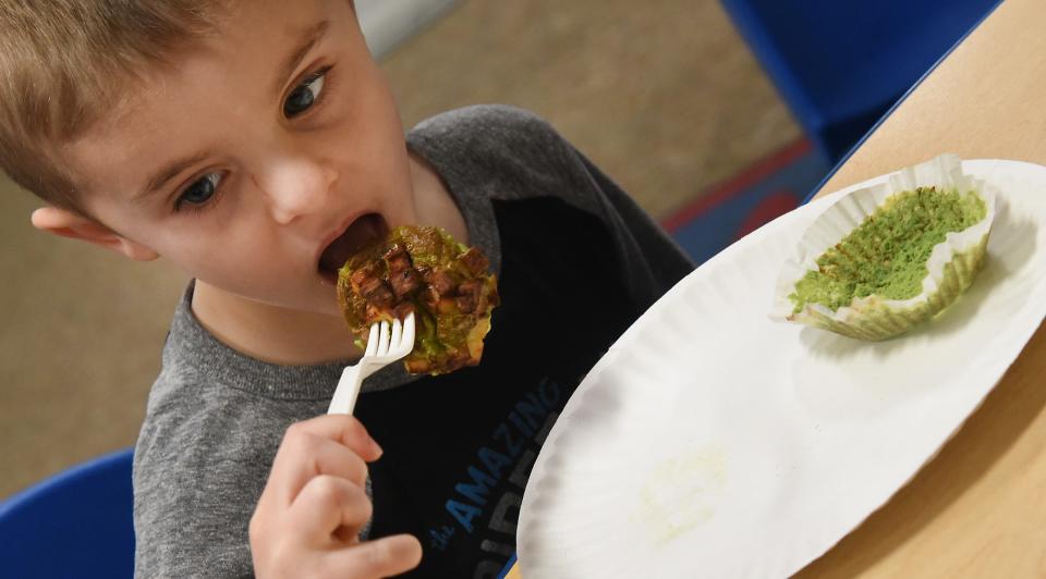 Logan Opfermann, 4, takes a big bite of the monster green avocado, turkey and egg bites.