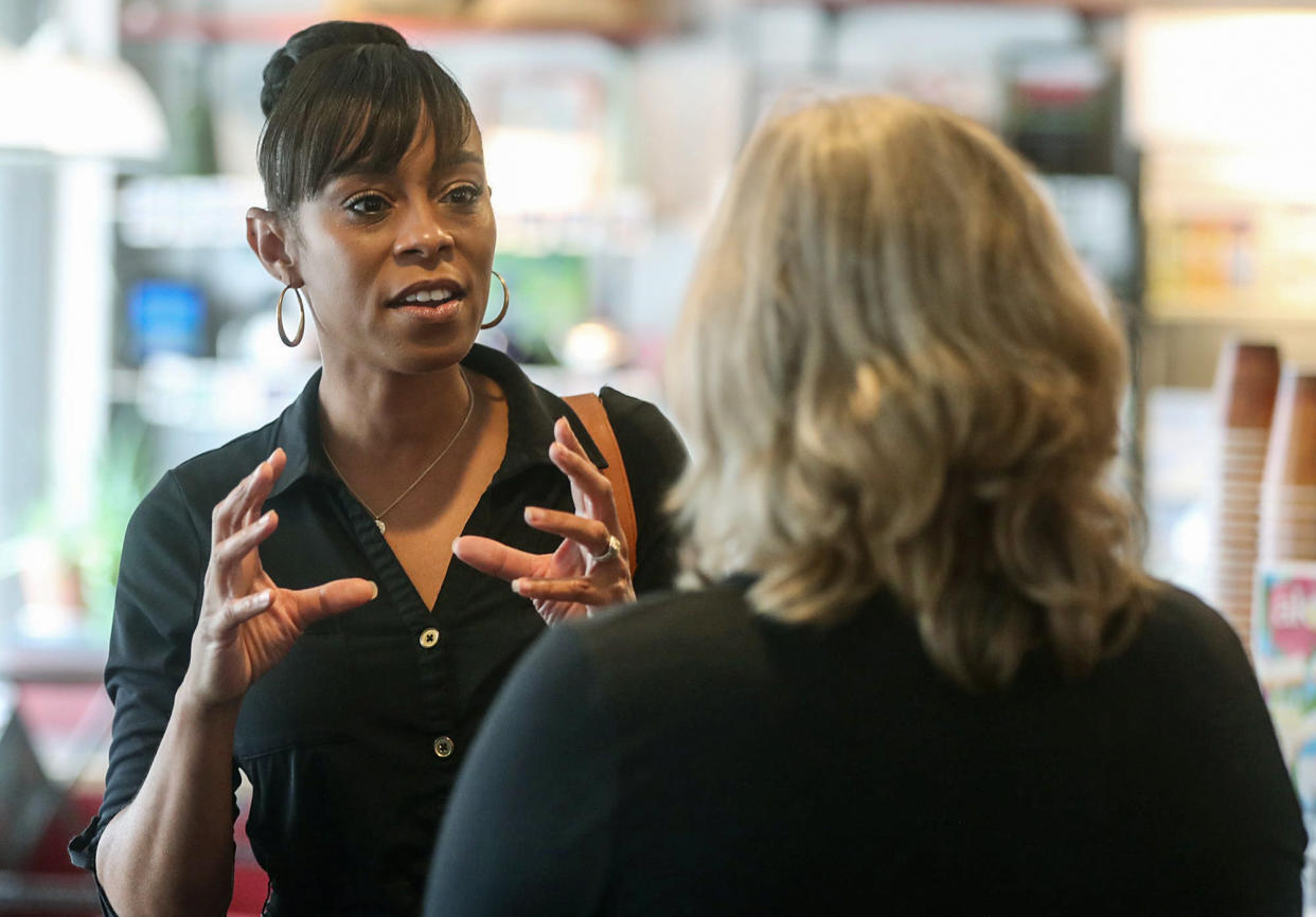 Shontel Brown, a candidate vying to represent Ohio's 11th Congressional District, talks with Nancy Holland, Akron city council ward 1, at Angel Falls Coffee shop during a campaign stop in Akron on July 14, 2021. (Mike Cardew / Akron Beacon Journal file)