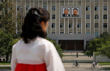 Portraits of late North Korean leaders Kim Il Sung and Kim Jong Il are seen on the facade of a government building in Pyongyang, North Korea, September 11, 2018. REUTERS/Danish Siddiqui