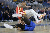 Atlanta Hawks guard Dejounte Murray lands on top of Orlando Magic guard Markelle Fultz while going for a loose ball during the first half of an NBA basketball game Wednesday, Nov. 30, 2022, in Orlando, Fla. (AP Photo/Phelan M. Ebenhack)