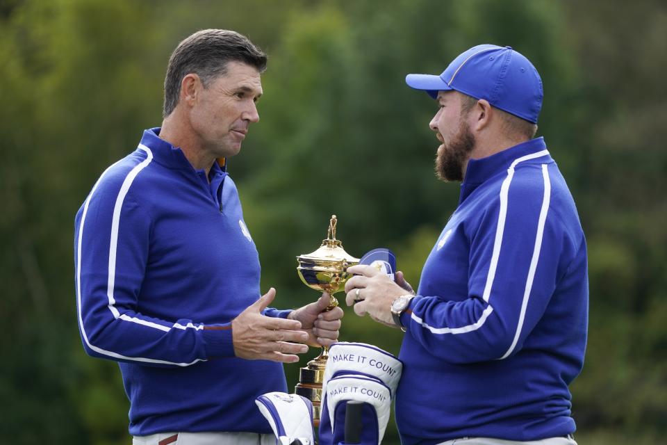 Team Europe captain Padraig Harrington talks to Team Europe's Shane Lowry during a practice day at the Ryder Cup at the Whistling Straits Golf Course Tuesday, Sept. 21, 2021, in Sheboygan, Wis. (AP Photo/Charlie Neibergall)