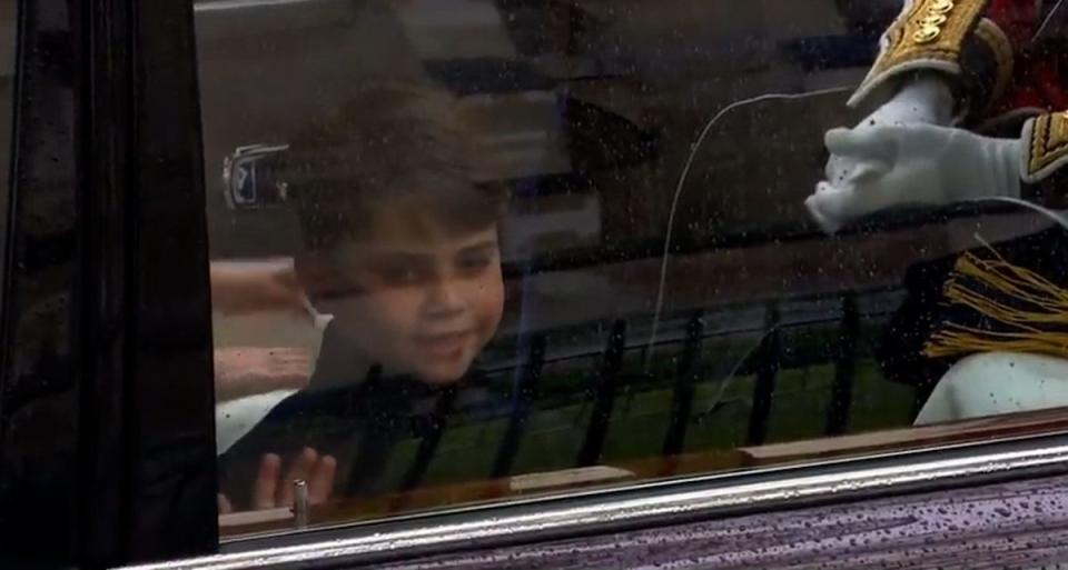 Prince Louis waves at the coronation crowd as he travels to Westminster Abbey (BBC)