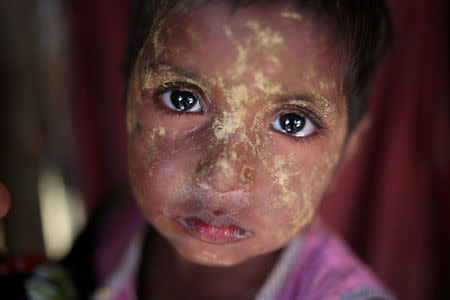 A Rohingya girl reacts to the camera as she applies makeup in Balukhali refugee camp in Cox's Bazar, Bangladesh, January 20, 2018. REUTERS/Mohammad Ponir Hossain