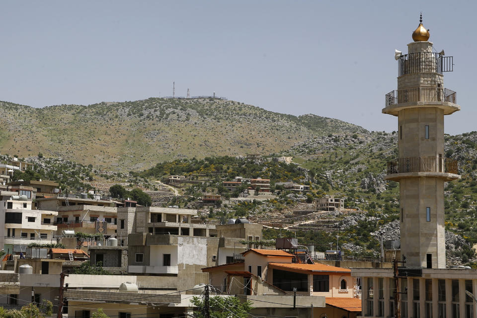 An Israeli military position on a hill on the top of Mount Hermon in the Israeli-controlled Golan Heights is seen from Kfar Chouba village, where the borders between Israel, Syria and Lebanon meet, in southeast Lebanon, Wednesday, May 20, 2020. Twenty years after Hezbollah guerrillas pushed Israel’s last troops from southern Lebanon, both sides are gearing up for what could be another war, one that neither seems to want. (AP Photo/Bilal Hussein)