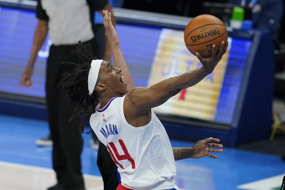 Los Angeles Clippers guard Terance Mann (14) shoots in the second half of an NBA basketball game against the Oklahoma City Thunder, Sunday, May 16, 2021, in Oklahoma City. (AP Photo/Sue Ogrocki)