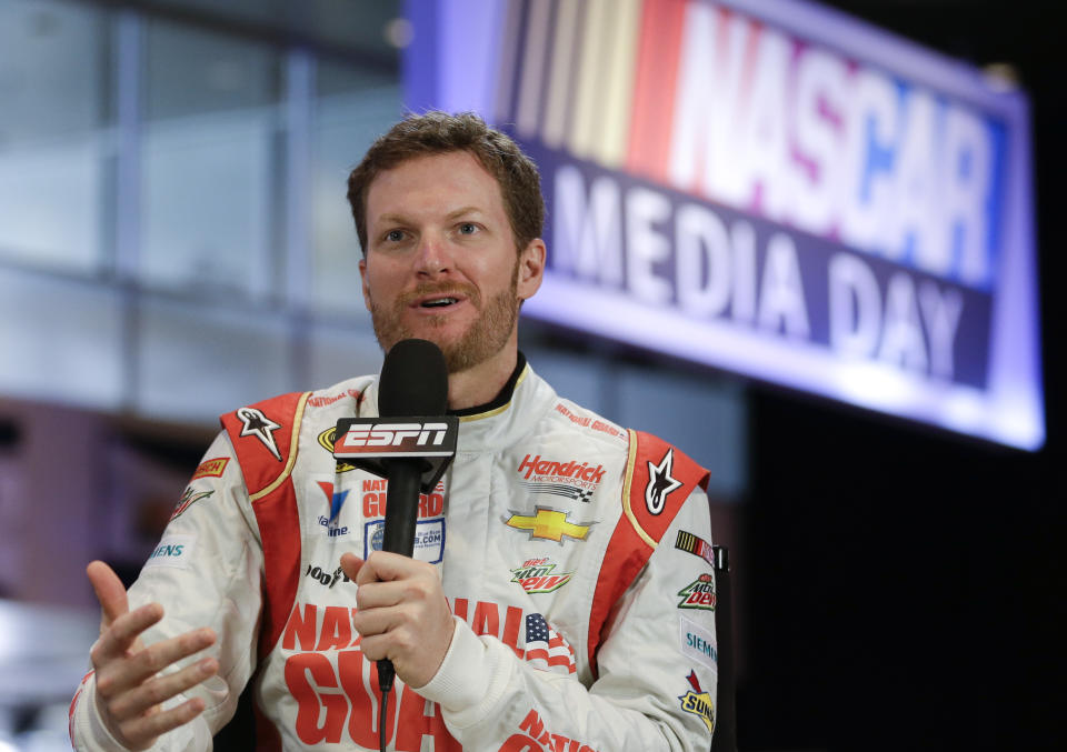 Driver Dale Earnhardt Jr. answers a question during a live TV interview at NASCAR auto racing media day at Daytona International Speedway in Daytona Beach, Fla., Thursday, Feb. 13, 2014. (AP Photo/John Raoux)