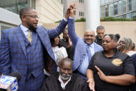 Civil lead counsel Malik Shabazz, left, raises the hand of co-counsel Trent Walker as they celebrate the federal sentencing of the sixth former Rankin County law enforcement officer, former Richland, Miss., police officer Joshua Hartfield, to 10 years in federal prison for his role with five other former Rankin County Sheriff's Department deputies in the racially motivated, violent torture of Michael Corey Jenkins and his friend, Eddie Terrell Parker, Thursday, March 21, 2024, at the federal courthouse in Jackson, Miss. The judge gave sentences near the top of federal guidelines to the former deputies. (AP Photo/Rogelio V. Solis)