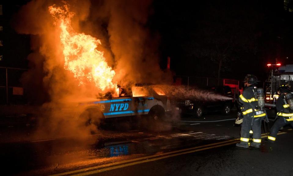 Firefighters put out a fire on a SUV of New York police department in the Brooklyn borough of New York.