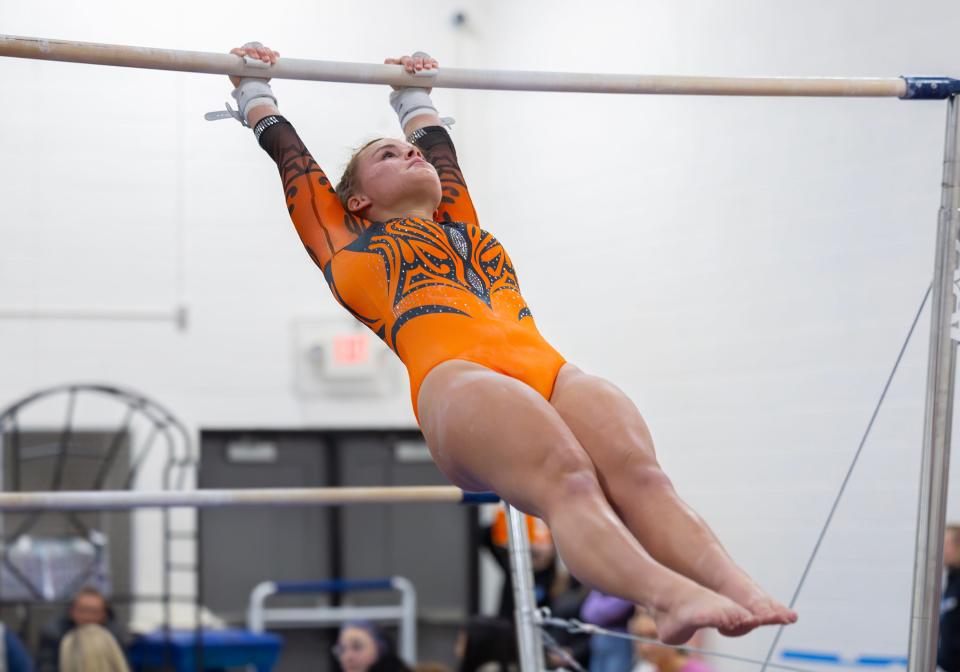 Tecumseh's Madi Rentfro competes in the uneven bars during Wednesday's meet at Adrian.